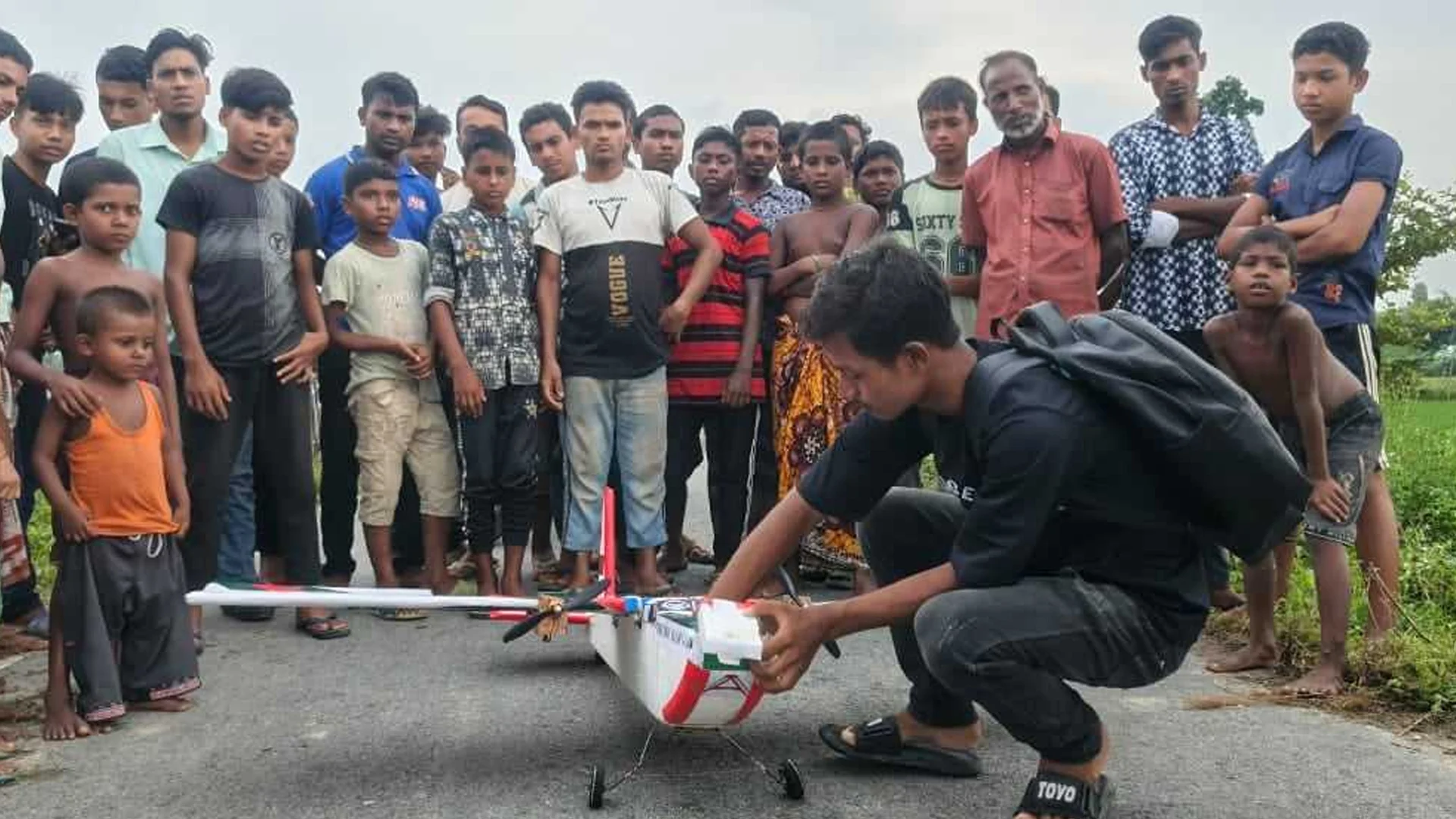 Airplane made by a village teenager is flying in the sky